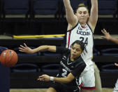 Providence guard Chanell Williams (2) passes the ball as Connecticut guard Anna Makurat (24) defends in the first half of an NCAA college basketball game at Harry A. Gampel Pavilion, Saturday, Jan. 9, 2021, in Storrs, Conn. (David Butler II/Pool Photo via AP)