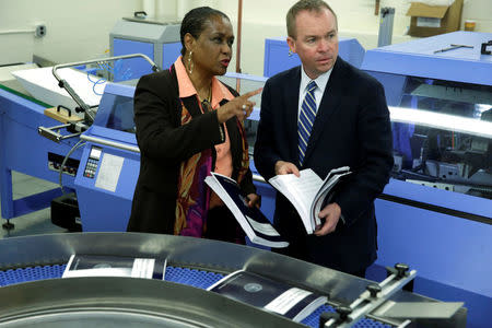 Office of Management and Budget (OMB) Director Mick Mulvaney (R) and Government Publishing Office Director Davita Vance-Cooks inspect the FY2018 budget production run in Washington, U.S., May 19, 2017. REUTERS/Yuri Gripas