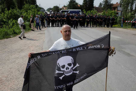 A supporters of Serbian Radical Party leader Vojislav Seselj holds "Chetnik" fighters flag during a protest in the village of Jarak, near Hrtkovci, Serbia, May 6, 2018. REUTERS/Marko Djurica