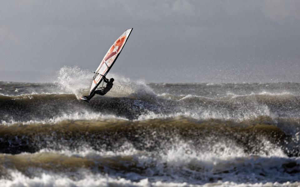 A windsurfer in Porthcawl, Wales. The area has an amber warning for wind on Friday and Saturday - Dimitris Legakis/Athena Picture Agency