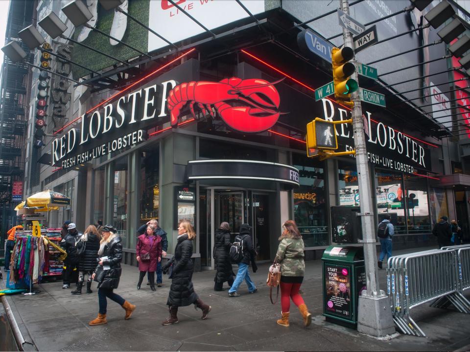 People walk outside a Red Lobster in Times Square, New York.