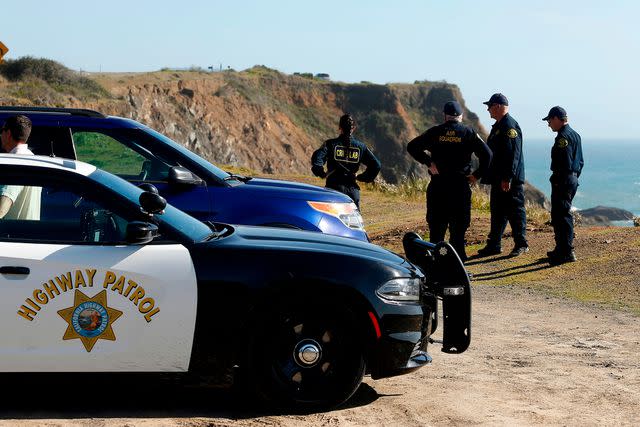 <p>Alvin Jornada/The Press Democrat/AP</p> California Highway Patrol officers and deputy sheriffs from Mendocino and Alameda counties gather after a search for three missing children at the site where the bodies of Jennifer and Sarah Hart and three of their adopted children were recovered.