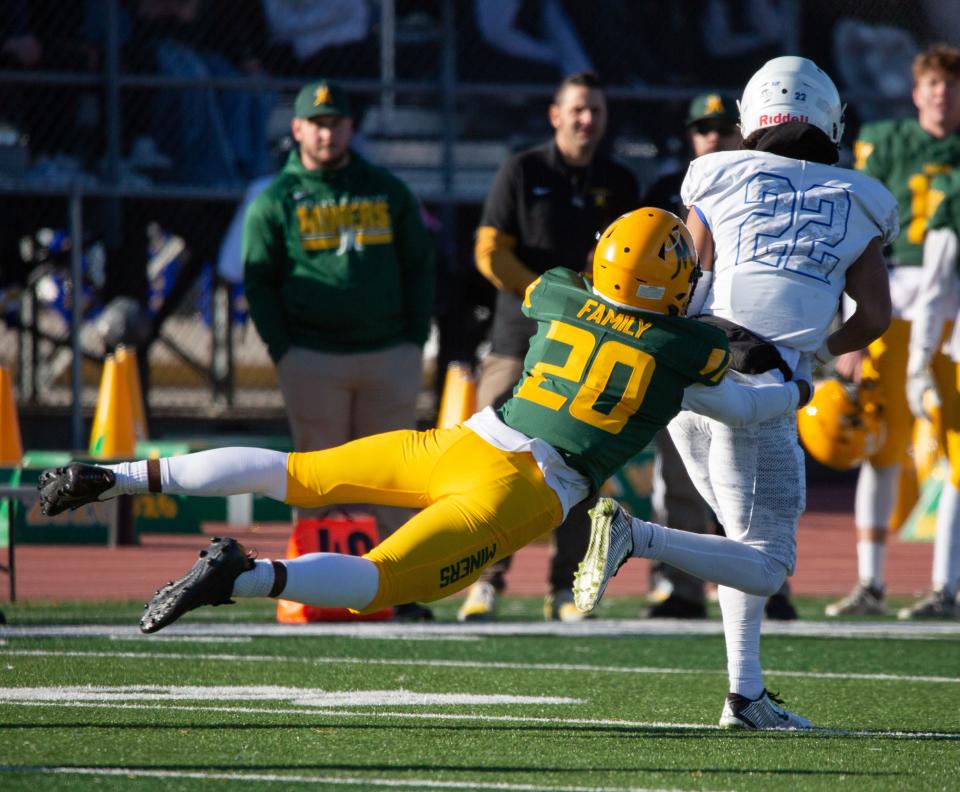 Bishop Manogue's Pele Masina leaps to stop Bishop Gorman's Micah Kaapana at the state championship game at Carson High School on Nov. 19, 2022.