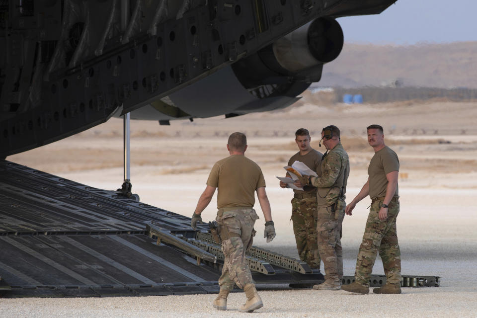 In this Oct. 24, 2019, photo, released by the U.S. Army Reserve, U.S. Airmen check their manifest for military equipment to be loaded onto a cargo plane at Kobani Landing Zone (KLZ), Syria. Pivoting from the dramatic killing of the Islamic State group's leader, the Pentagon is increasing U.S. efforts to protect Syria's oil fields from the extremist group as well as from Syria itself and the country's Russian allies. It's a new high-stakes mission even as American troops are withdrawn from other parts of the country.(U.S. Army Reserve photo by Staff Sgt. Joshua Hammock via AP)