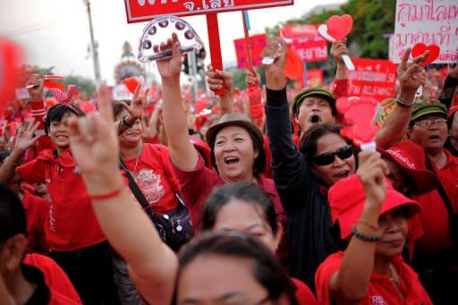 Thai anti-government 'Red Shirt' protesters shout slogans during a rally at Democracy Monument in downtown Bangkok. Tens of thousands of anti-government "Red Shirts" protested in Bangkok Saturday in a major show of strength to mark a year since the start of a mass rally in the capital that turned deadly