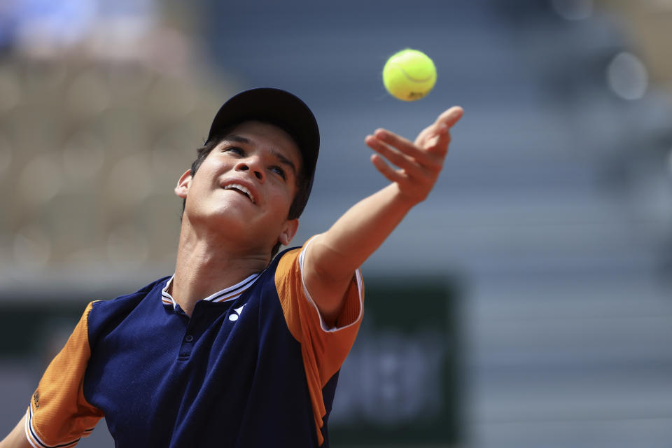 Bolivia's Juan Carlos Prado Angelo serves against Croatia's Dino Prizmic during their final match of the Boys' Singles French Open tennis tournament at the Roland Garros stadium in Paris, Saturday, June 10, 2023. (AP Photo/Aurelien Morissard)