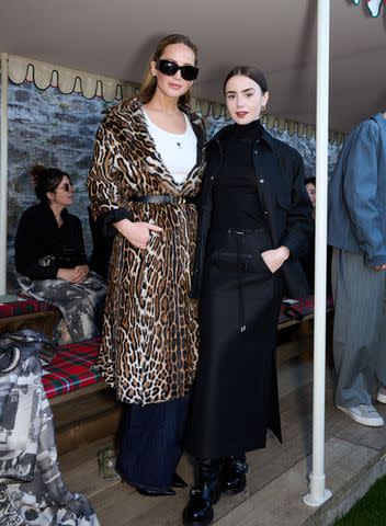 <p>Saira Macleod/WWD via Getty</p> Lawrence caught up with Lily Collins at the show