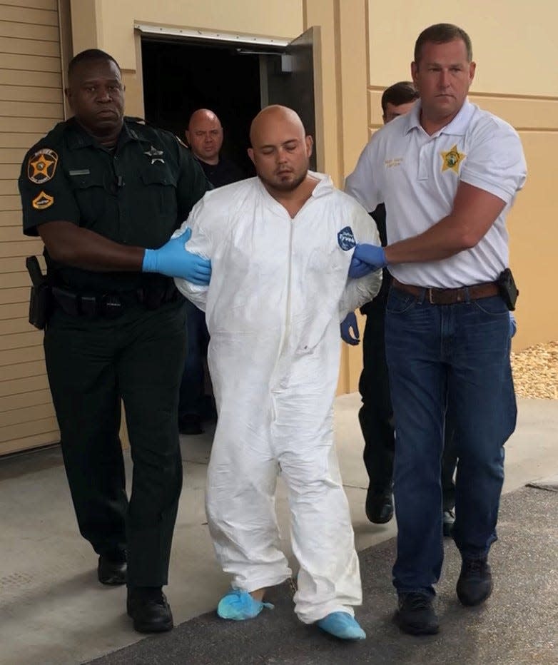 Quadruple homicide suspect Bryan James Riley is led from the Polk County Sheriff’s office on Sept. 6.