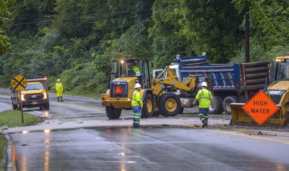 Crews work to remove debris blocking U.S. Route 60 near Cedar Grove, W.Va., on Monday, Aug. 28, 2023. Parts of the area received up to 6 inches of rain. (Kenny Kemp/Charleston Gazette-Mail via AP)