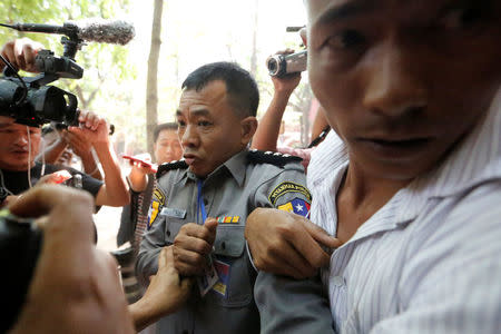 Prosecution witness police captain Moe Yan Naing walks outside the court room during a hearing of detained Reuters journalists Wa Lone and Kyaw Soe Oo in Yangon, Myanmar April 20, 2018 . REUTERS/Ann Wang