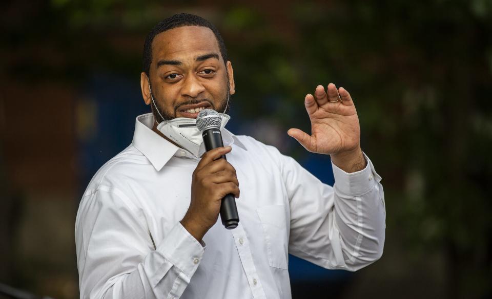 State Rep. Charles Booker gestures while speaking to an enthusiastic crowd at Highland Coffee Company on Bardstown Road on Wednesday, June 17, 2020.