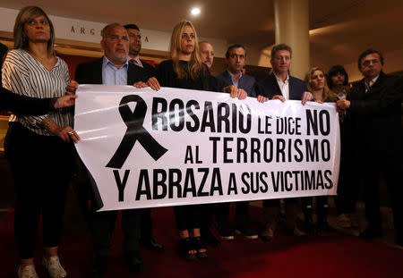 Members of Rosario's City council display a banner during a ceremony in honour of the five Argentine citizens of Rosario who were killed in the truck attack in New York on October 31, at the National Flag Memorial in Rosario, Argentina November 2, 2017. The banner reads "Rosario says No to terrorism and embraces its victims". REUTERS/Marcos Brindicci