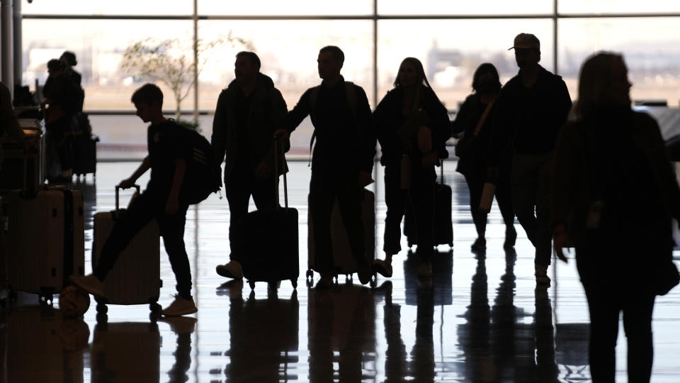 FILE - People pass through Salt Lake City International Airport Wednesday, Jan. 11, 2023, in Salt Lake City. Flight attendants for major U.S. airlines are holding rallies at airports around the country to push for higher pay, Tuesday, Feb. 13, 2024. The protests are not, however, a strike. (AP Photo/Rick Bowmer, File)