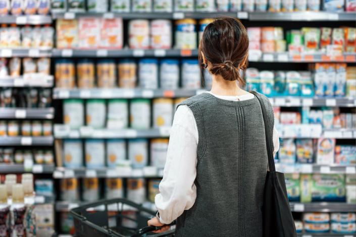Woman reading labels in grocery store
