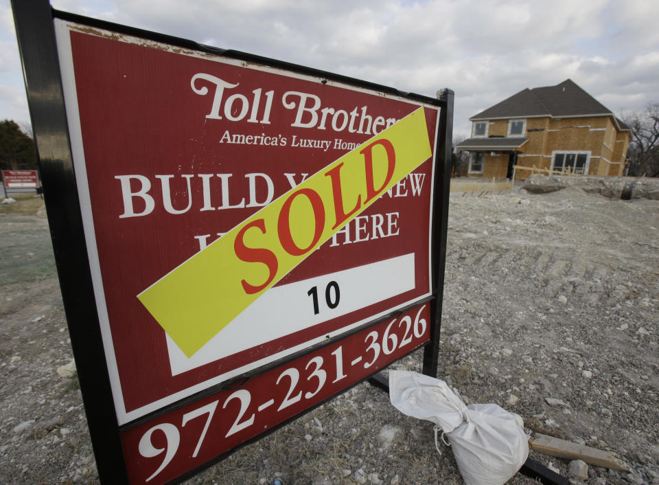 In this Feb. 20, 2011 photo, a sold sign sits in front of home built by Toll Brothers construction in Richardson, Texas. Toll Brothers Inc. posted a surprise first-quarter profit, helped by a larger tax benefit, a higher average delivery price for its homes and more normalized cancellation rates.(AP Photo/LM Otero)