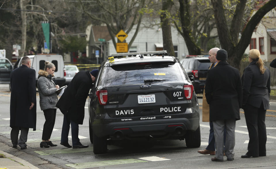 Authorities inspect the patrol vehicle driven by Davis Police Officer Natalie Corona, Friday, Jan. 11, 2019, in Davis, Calif. Corona, 22, who had been on the job only a few weeks, was shot and killed Thursday. The suspect was later found dead from a self-inflicted gunshot. (AP Photo/Rich Pedroncelli)