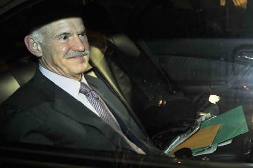 Greek Prime Minister George Papandreou leaves the presidental palace in Athens following his meeting with Greece's president and opposition leader. Papandreou agreed to step down and political leaders will meet tomorrow to form a new unity government to end the political crisis, the president's office said