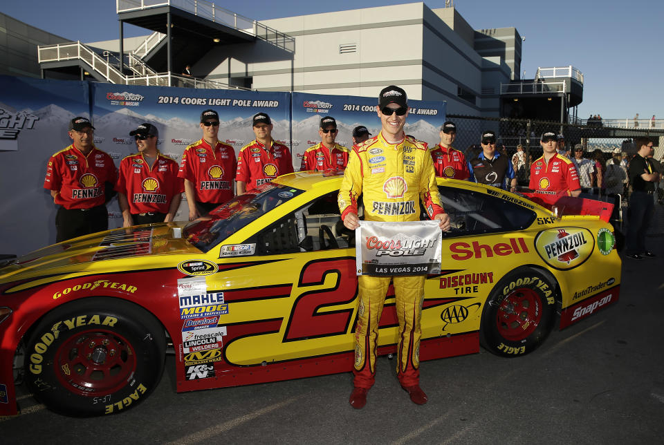 Joey Logano poses for photos after winning the pole position for Sunday's NASCAR Sprint Cup Series auto race, Friday, March 7, 2014, in Las Vegas. (AP Photo/Isaac Brekken)