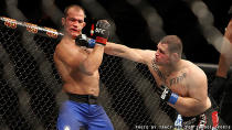 Cain Velasquez punches Junior dos Santos during their fight at UFC 155. (Courtesy: Tracy Lee for Y! Sports)