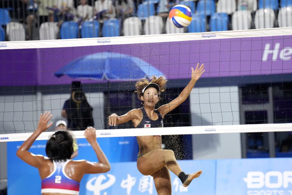 Japan's Miki Ishii, right, who paired with Sayaka Mizoe, not in picture, plays against Floremel Rodriguez and Genesa Jane Eslapor of Philippines during Women's beach volleyball quarterfinal match at the 19th Asian Games in Ningbo, China, Monday, Sept. 25, 2023. (AP Photo/Eugene Hoshiko)