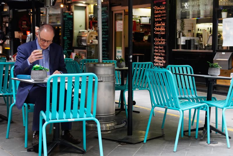 A man dines at a cafe after coronavirus disease restrictions were eased in Melbourne