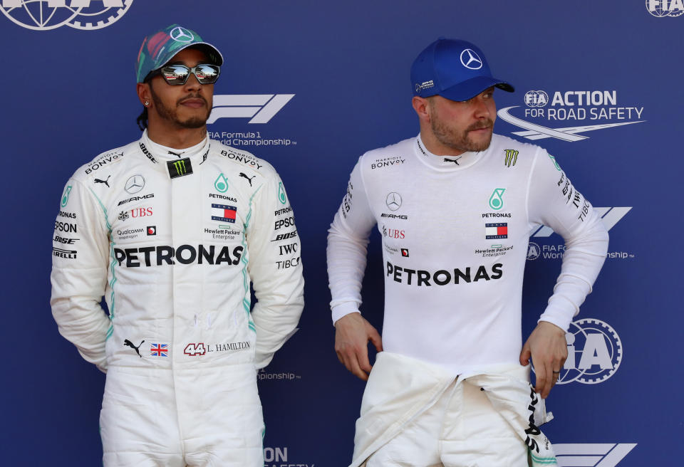 Mercedes driver Valtteri Bottas of Finland, right, pole position, is flanked buy his teammate Lewis Hamilton of Britain, second fastest time, after the qualifying session at the Barcelona Catalunya racetrack in Montmelo, just outside Barcelona, Spain, Saturday, May 11, 2019. The Formula One race will take place on Sunday. (AP Photo/Manu Fernandez)