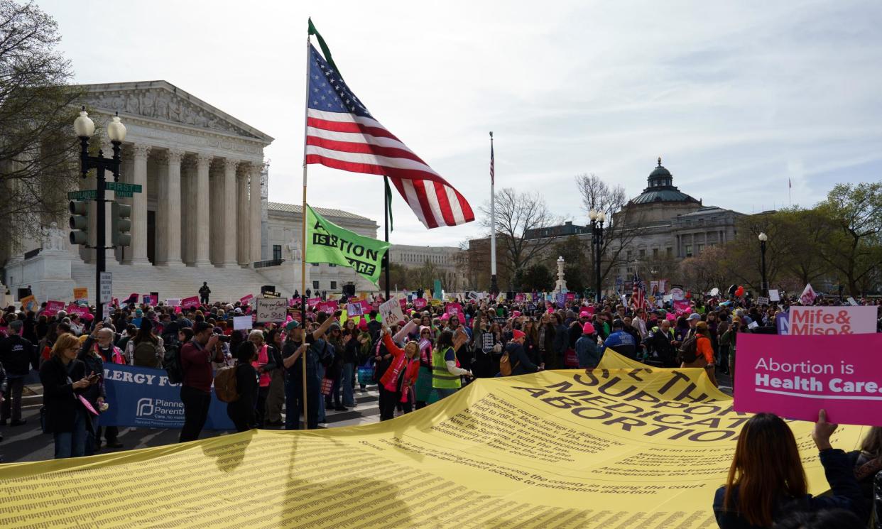 <span>A banner with the names of pro-choice supporters is carried at a rally outside the US supreme court on Tuesday.</span><span>Photograph: Will Oliver/EPA</span>