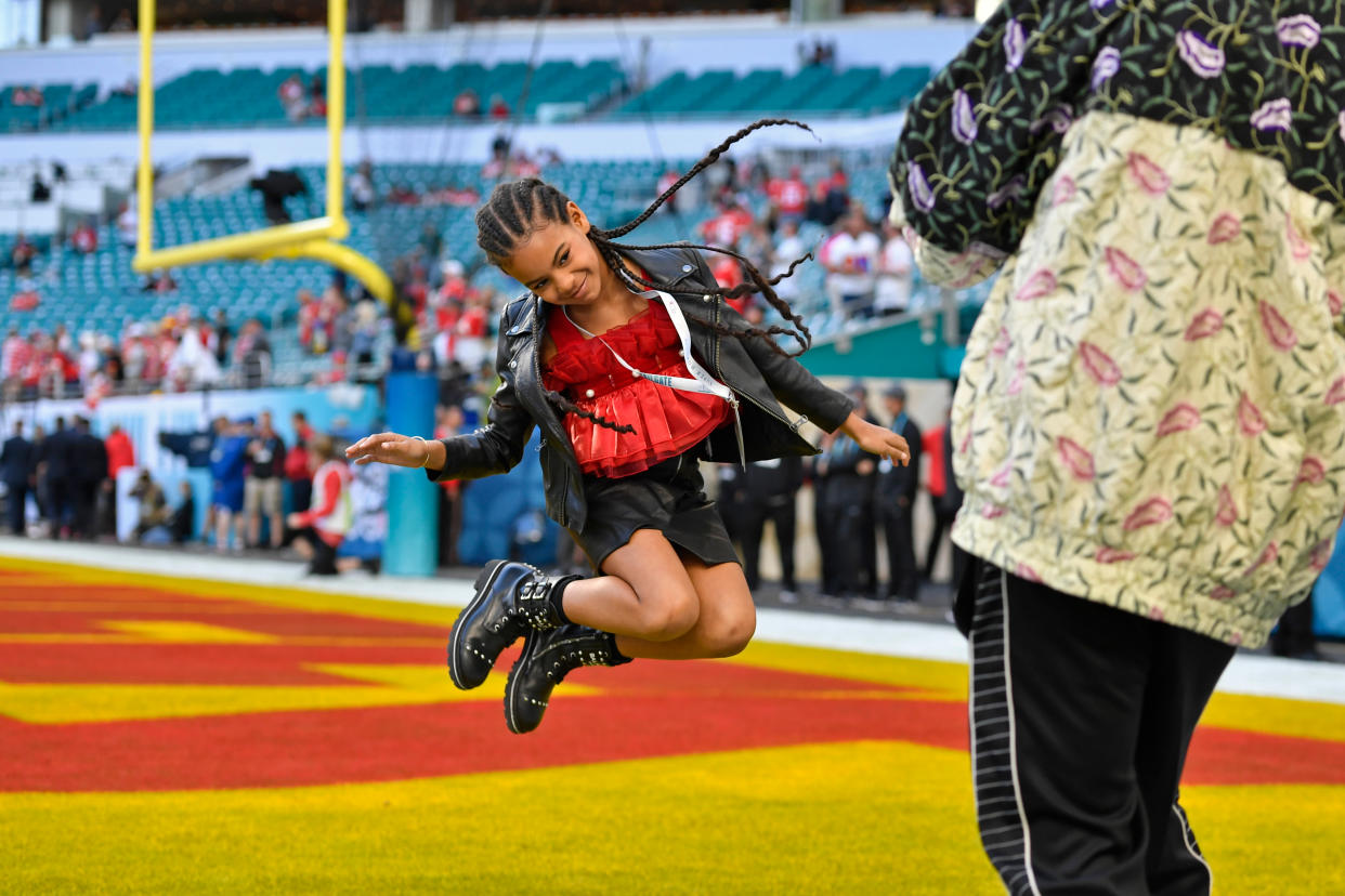 MIAMI GARDENS, FLORIDA -  FEBRUARY 2: Jay-Z photographs his daughter Blue Ivy Carter as she jumps in the end zone before the start of Super Bowl LIV at Hard Rock Stadium in Miami Gardens, Fla., on Sunday, Feb. 2, 2020. (Jose Carlos Fajardo/MediaNews Group/The Mercury News via Getty Images)