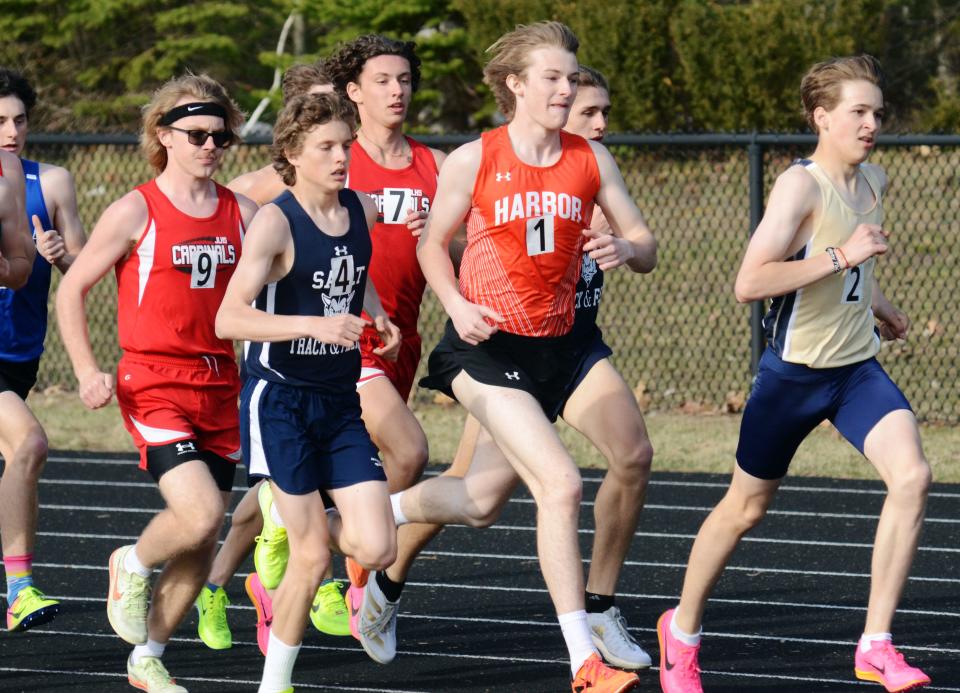 Harbor Springs' Cal Benjamin tries to break free from a pack of runners at the front of the 1600 meter run on Friday. Benjamin ended the race in third overall.