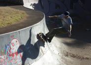 Skateboarder Dallas Oberholzer, 46, rides at the Germiston Lake Skateboard Park, near Johannesburg, Saturday, July 3, 2021. The age-range of competitors in skateboarding's Olympic debut at the Tokyo Games is remarkably broad and 46-year-old Dallas Oberholzer will go wheel-to-wheel with skaters less than half his age. (AP Photo/Denis Farrell)