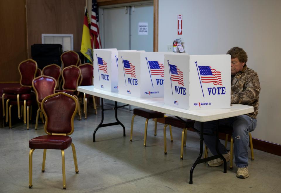 Paul Albright casts his paper ballot at the Bremen on Election Day at the Bremen Area Historical Society on Mar. 19, 2024, in Bremen, Ohio.