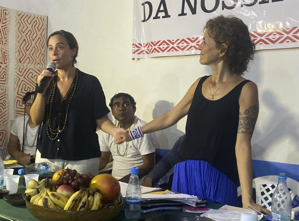 Beatriz Matos, widow of Indigenous expert Bruno Pereira, left, and Alessandra Sampaio, widow of British journalist Dom Phillips, attend a ceremony in Atalaia do Norte, Vale do Javari, Amazonas state, Brazil, Monday, Feb. 27, 2023. In a symbolic gesture, a high-level delegation from the Brazilian government paid a visit on Monday to the region where the Indigenous expert Bruno Pereira and British journalist Dom Phillips were murdered last year. (AP Photo/Fabiano Maisonnave)