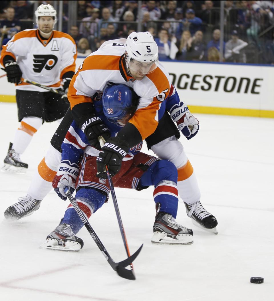 Philadelphia Flyers defenseman Braydon Coburn (5) smothers New York Rangers right wing Mats Zuccarello (36), of Norway, in the second period of Game 2 of the first round of the Stanley Cup hockey playoffs at Madison Square Garden in New York, Sunday, April 20, 2014. Coburn was called for holding. (AP Photo/Kathy Willens)