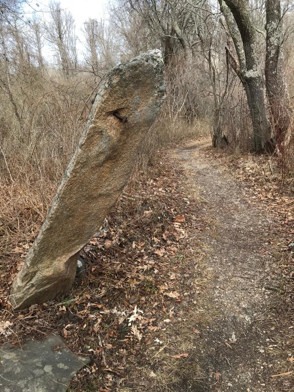 A granite post with an iron ring may have been a hitching post or part of a gate.