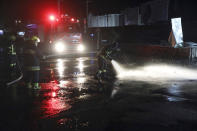 Afghan firefighters spray water at the scene of a bombing attack in Kabul, Afghanistan, Wednesday, April 21, 2021. An explosion in the Afghan capital Wednesday wounded at least five people, said an Afghan interior ministry official. (AP Photo/Rahmat Gul)