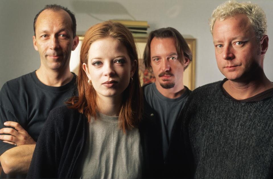 The four members of the band Garbage standing for a portrait.