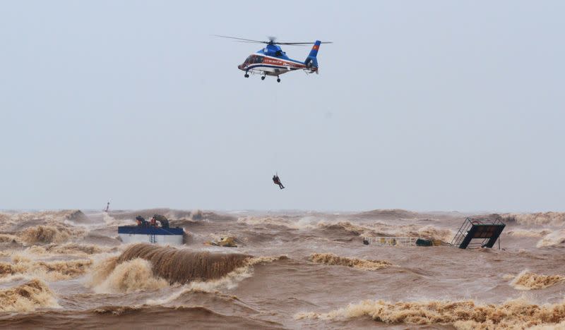 A military helicopter rescues sailors of a submerged ship at Cua Viet Port in Quang Tri province