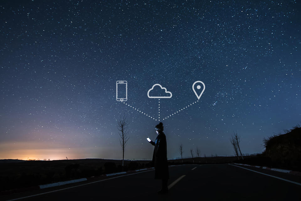 Woman using smartphone under a sky full of stars. Fairplay Canada, a coalition of artists, content creators, unions and guilds, aims to stop pirates stealing work on Canada’s corner of the web. (Getty Images)