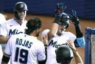 Miami Marlins' Brian Anderson (15) celebrates with Miguel Rojas (19) after hitting a three-run home run during the first inning of a baseball game against the Arizona Diamondbacks, Tuesday, May 4, 2021, in Miami. (AP Photo/Lynne Sladky)