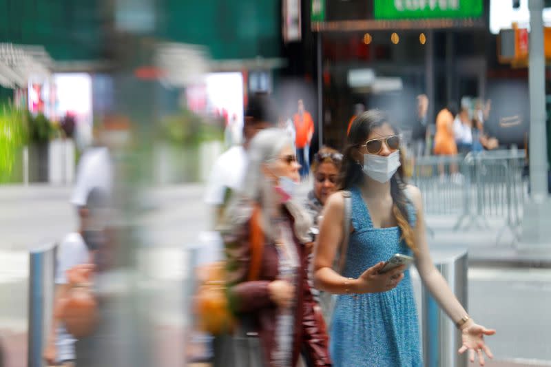 People wear masks as they walk in Times Square during the outbreak of the coronavirus disease (COVID-19) in Manhattan, New York City