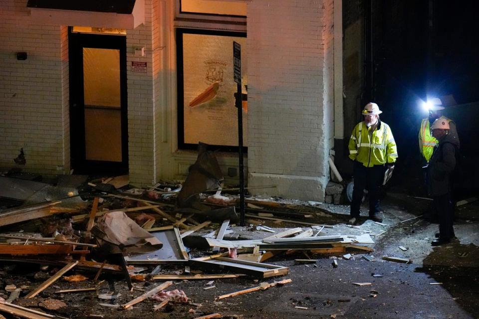 Officials survey an area near the Sandman Signature hotel following an explosion (AP)