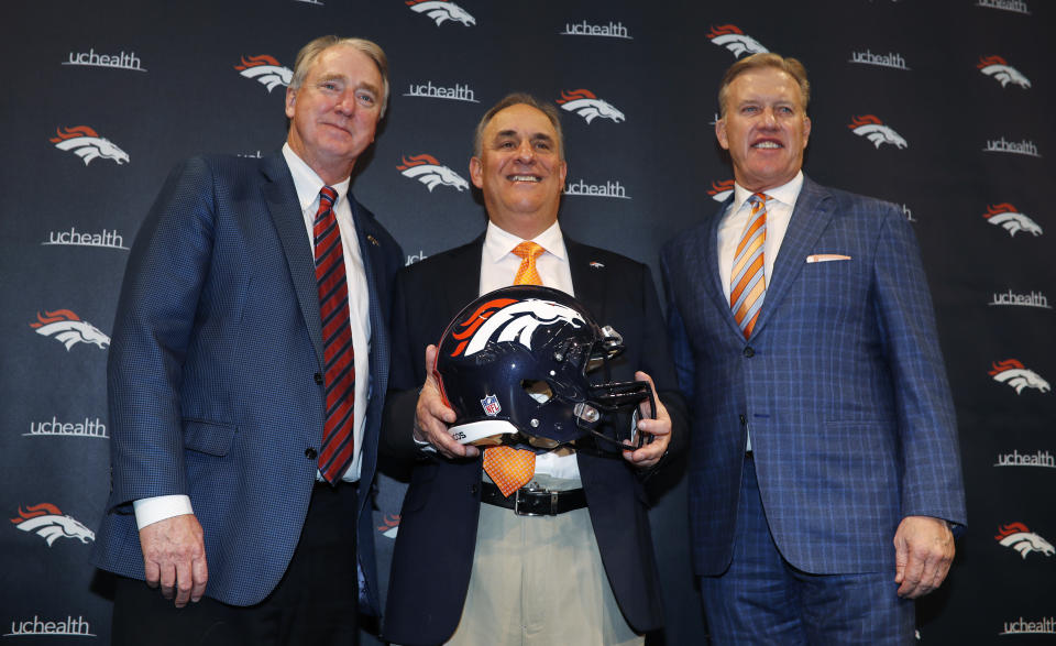 Denver Broncos new head coach Vic Fangio, center, joins team president Joe Ellis, left, and general manager John Elway for a photograph during a news conference at the team's headquarters Thursday, Jan. 10, 2019, in Englewood, Colo. (AP Photo/David Zalubowski)