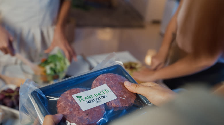 hands holding plant-based meat