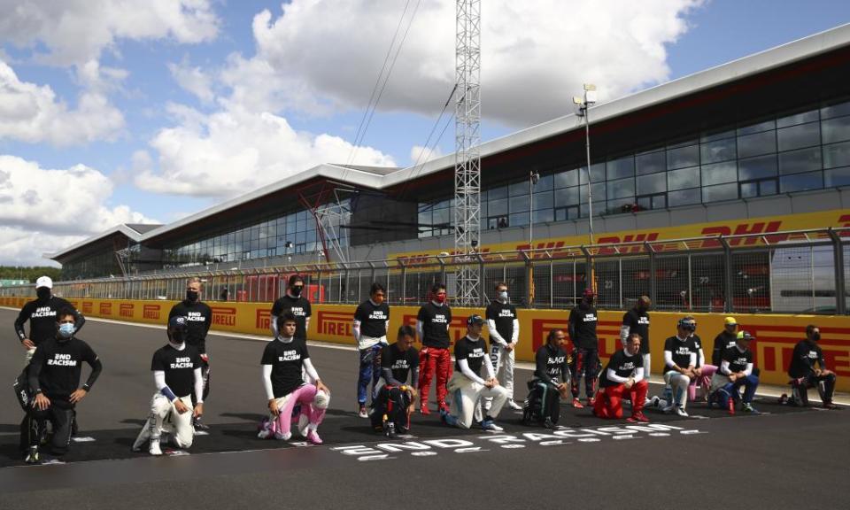 Drivers kneel during the anti-racism demonstration before the start of the race.