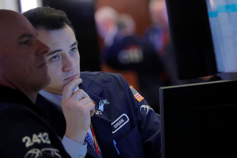 Traders work on the floor at the NYSE in New York