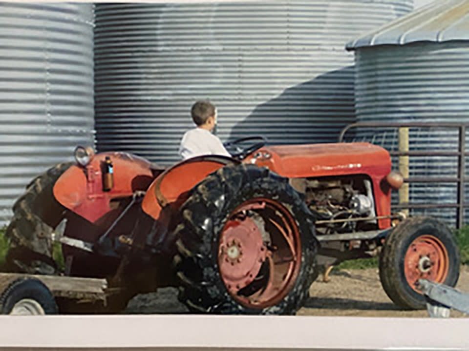 Dylan Rounds driving a Tractor as a child