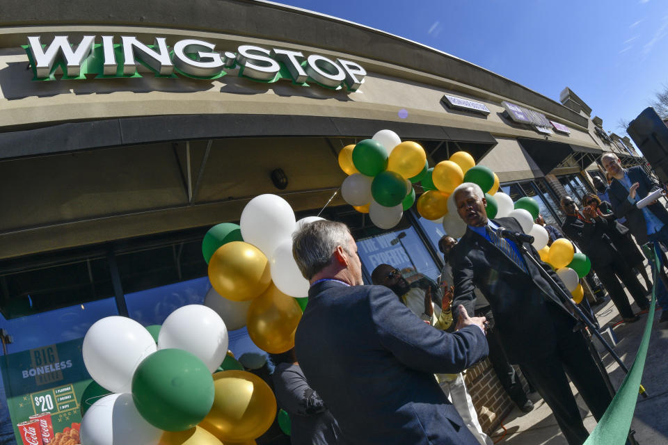 IMAGE DISTRIBUTED FOR WINGSTOP - Wingstop celebrates the milestone opening of its 1,000th restaurant as Wingstop Chief Executive Officer Charlie Morrison introduces U.S. Representative Hank Johnson, right, during a ribbon cutting ceremony on Thursday, Jan. 26, 2017, in Decatur, Ga. (John Amis/AP Images for Wingstop)