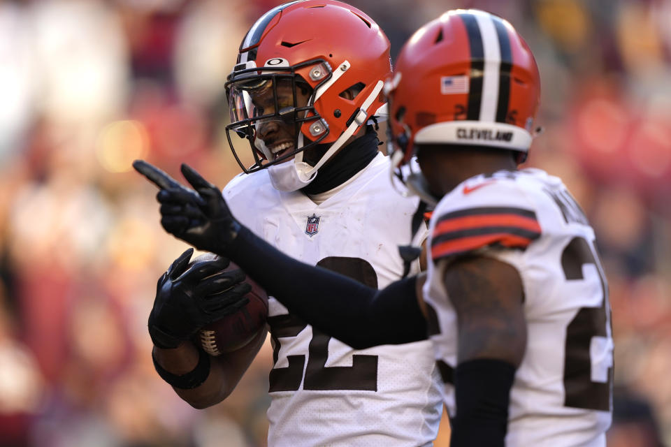 Cleveland Browns safety Grant Delpit (22) celebrates his interception with cornerback Greedy Williams (26)during the second half of an NFL football game against the Washington Commanders, Sunday, Jan. 1, 2023, in Landover, Md. (AP Photo/Susan Walsh)
