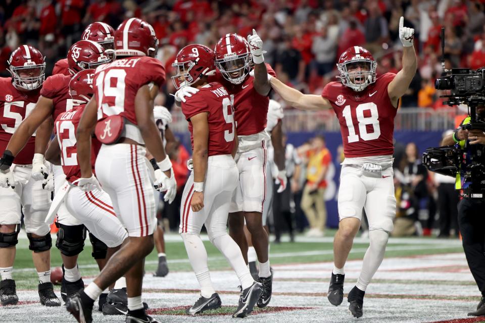 Alabama quarterback Bryce Young (9) celebrates his first-half touchdown run against Georgia during the SEC championship game at Mercedes-Benz Stadium.