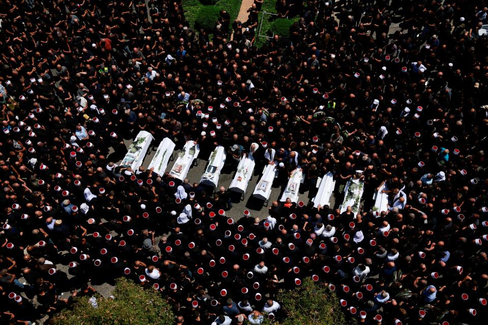 People gather during the funeral of children who were killed at a soccer field by a rocket Israel says was fired from Lebanon, in Majdal Shams, a Druze village in the Israeli-occupied Golan Heights, on July 28, 2024.